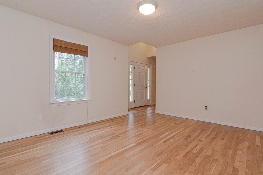 21 Shore Drive Upton, MA 01568 - Photo 13 of 29 a view of an empty room with wooden floor and a window