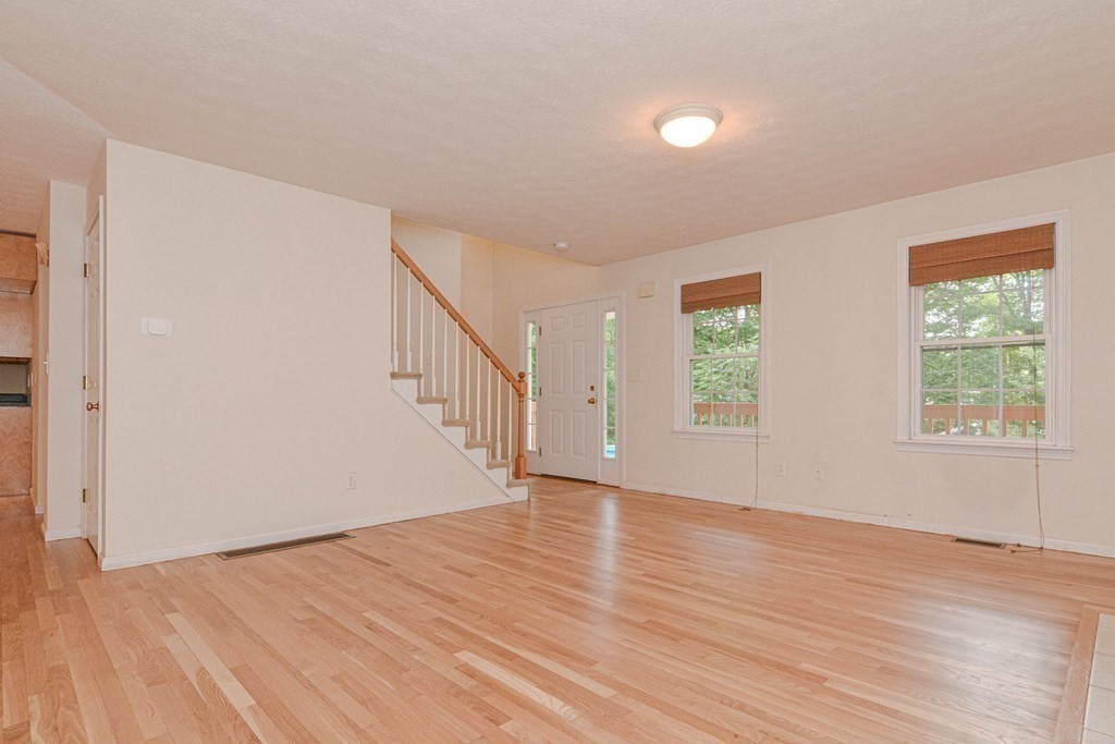 21 Shore Drive Upton, MA 01568 - Photo 3 of 29 a view of an empty room with wooden floor and a window