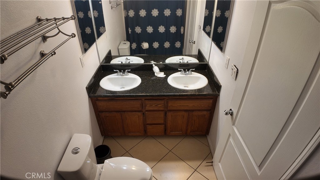 464 West E Street Colton, CA 92324 - Photo 13 of 21 a bathroom with a sink mirror and vanity