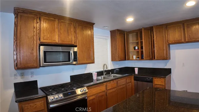 a kitchen with a sink a microwave and cabinets