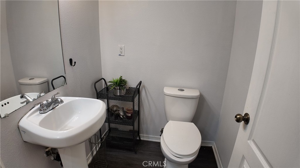 464 West E Street Colton, CA 92324 - Photo 9 of 21 a bathroom with a toilet sink and mirror