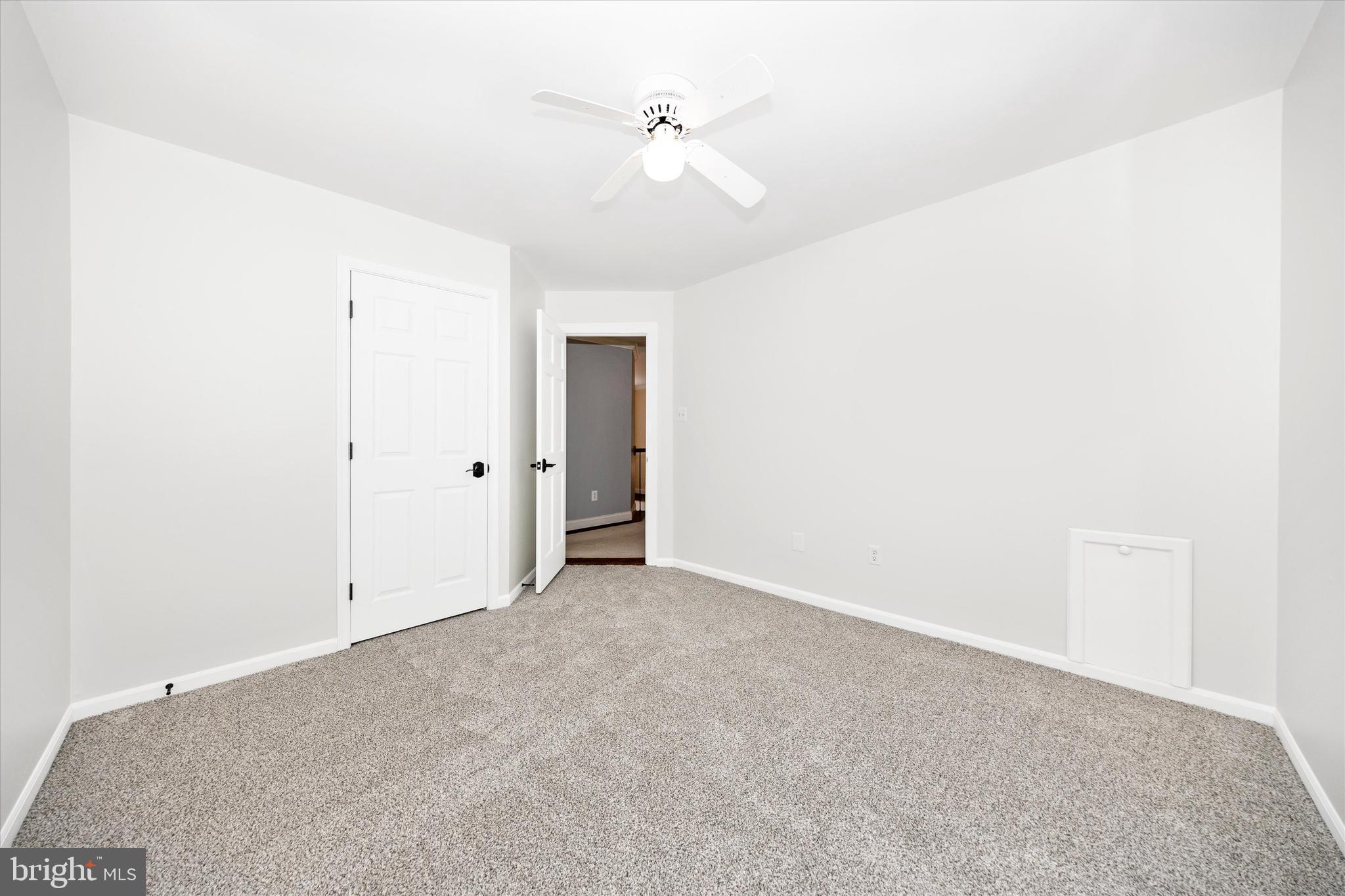 803 Apache Court Frederick, MD 21701 - Photo 23 of 46 an empty room with a ceiling fan and a window