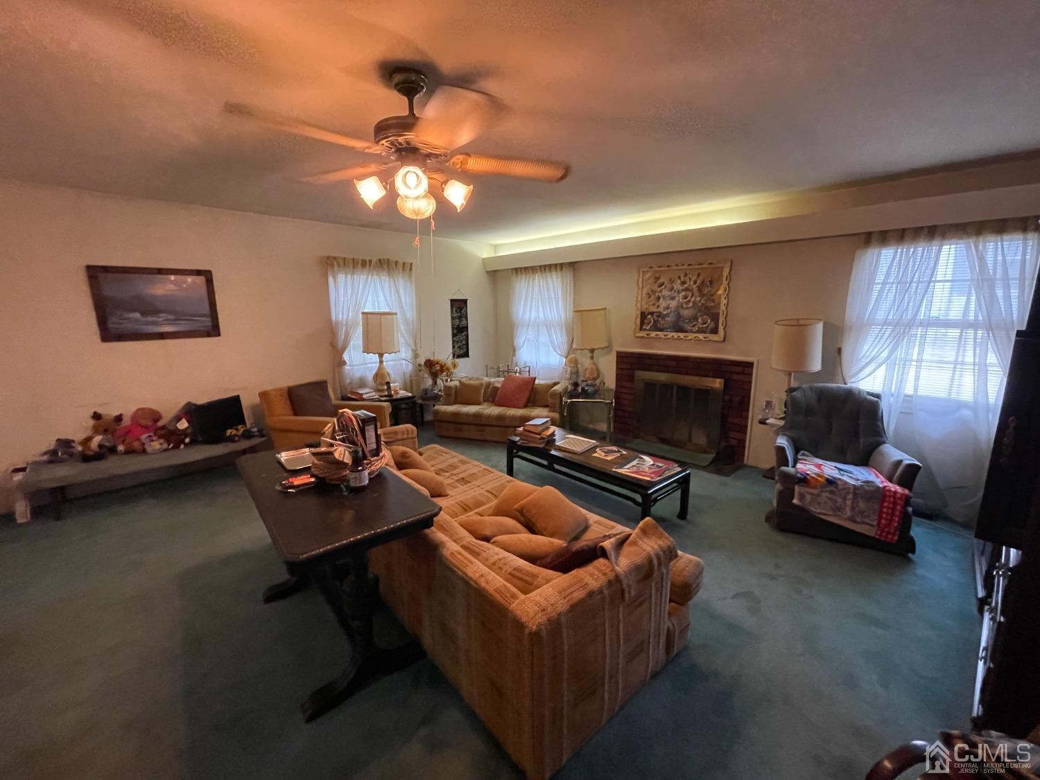 22 Abbott Road Somerset, NJ 08873 - Photo 5 of 15 a living room with furniture a fireplace and a flat screen tv