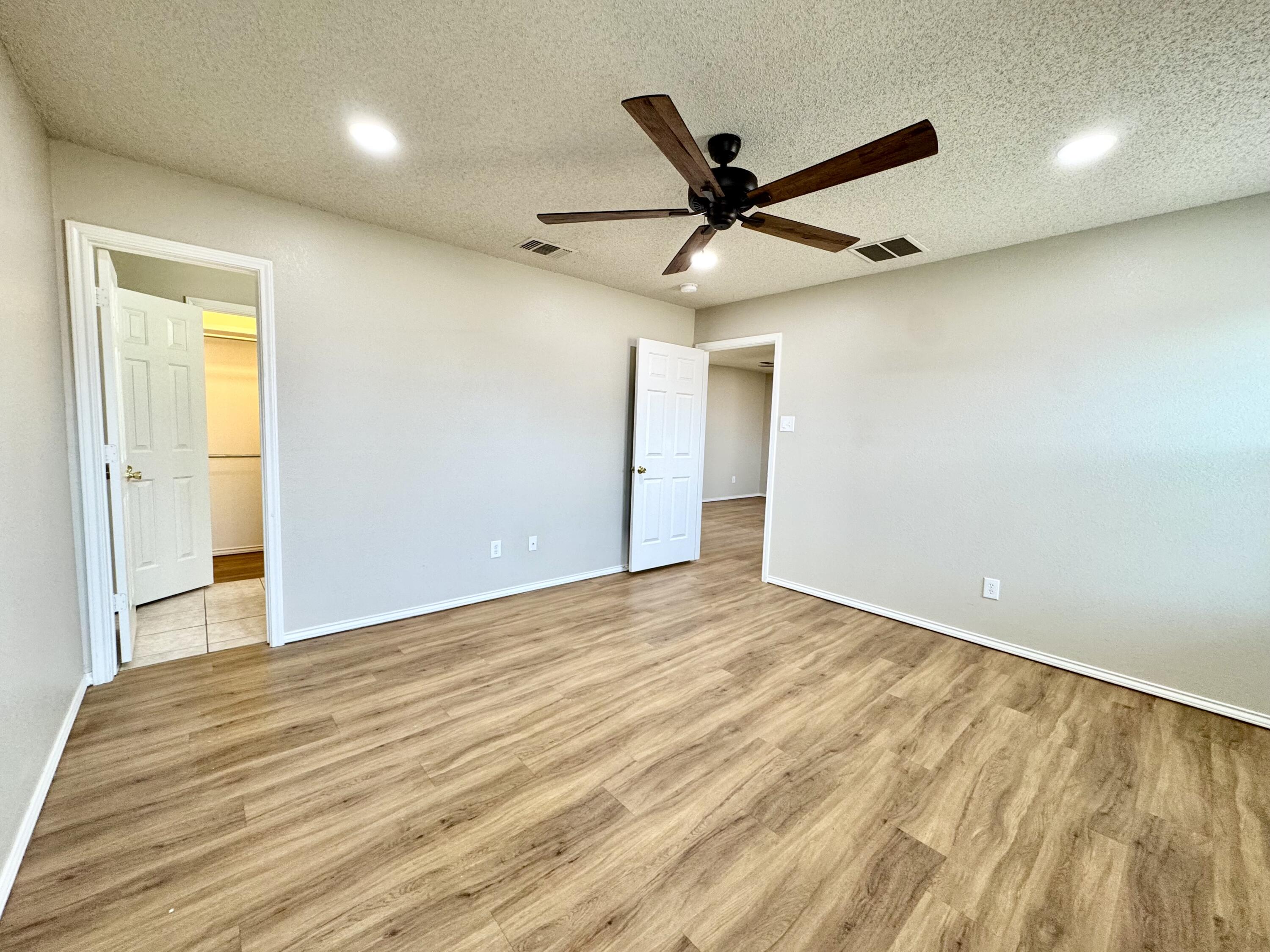 6536 7th Street Lubbock, TX 79416 - Photo 12 of 20 a view of empty room with wooden floor