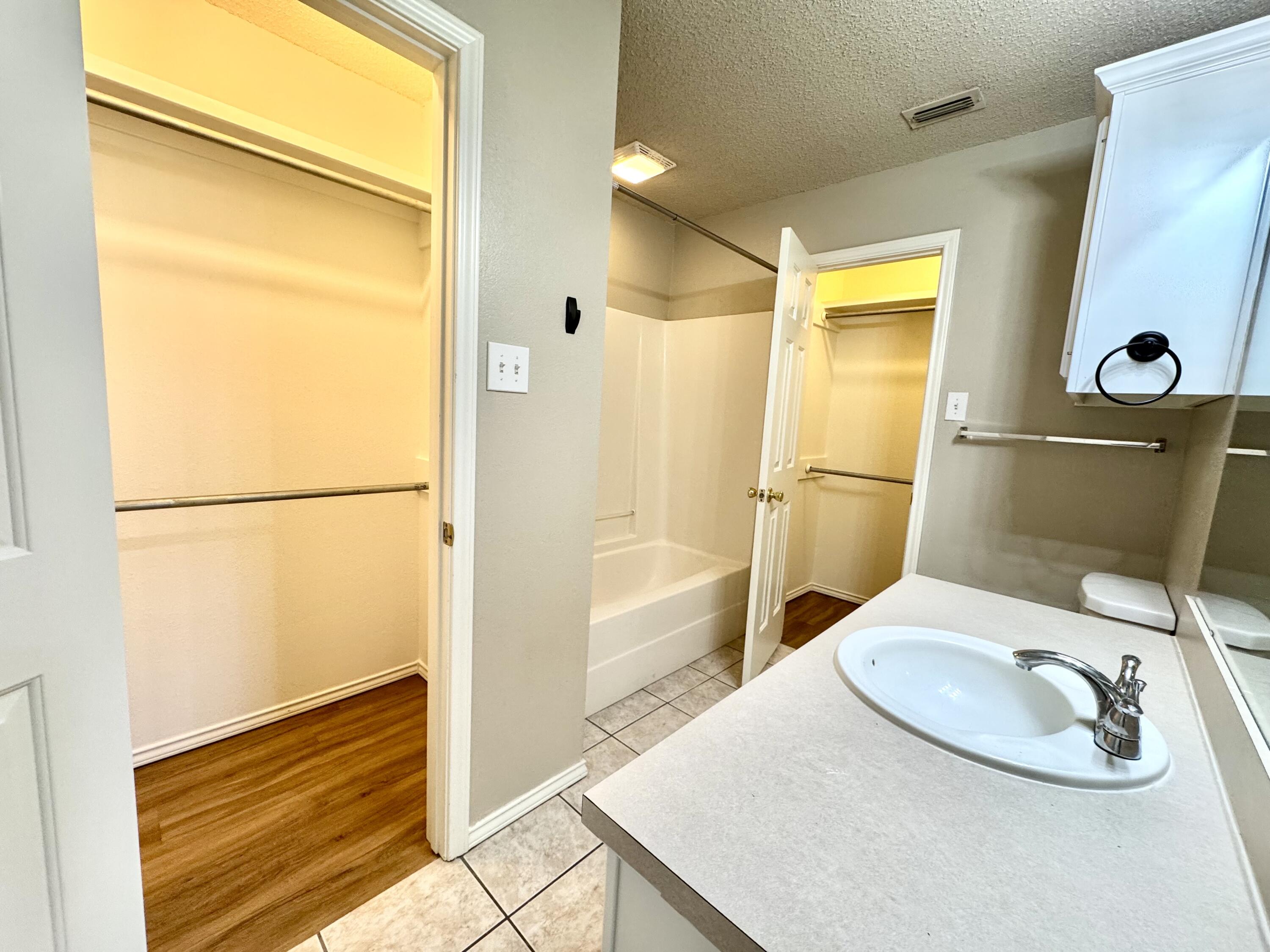 6536 7th Street Lubbock, TX 79416 - Photo 14 of 20 a bathroom with a sink and a mirror