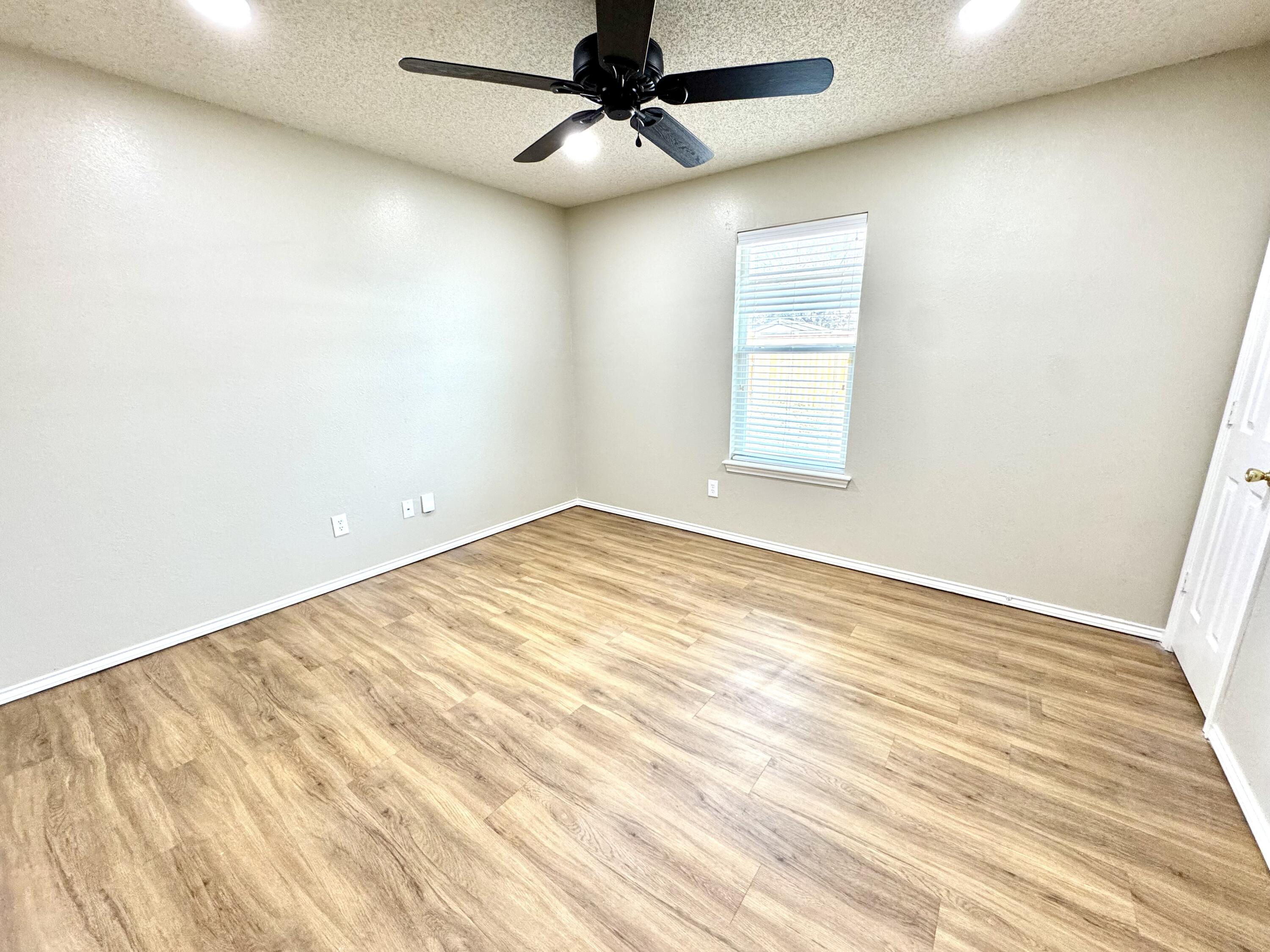 6536 7th Street Lubbock, TX 79416 - Photo 18 of 20 an empty room with a window and ceiling fan