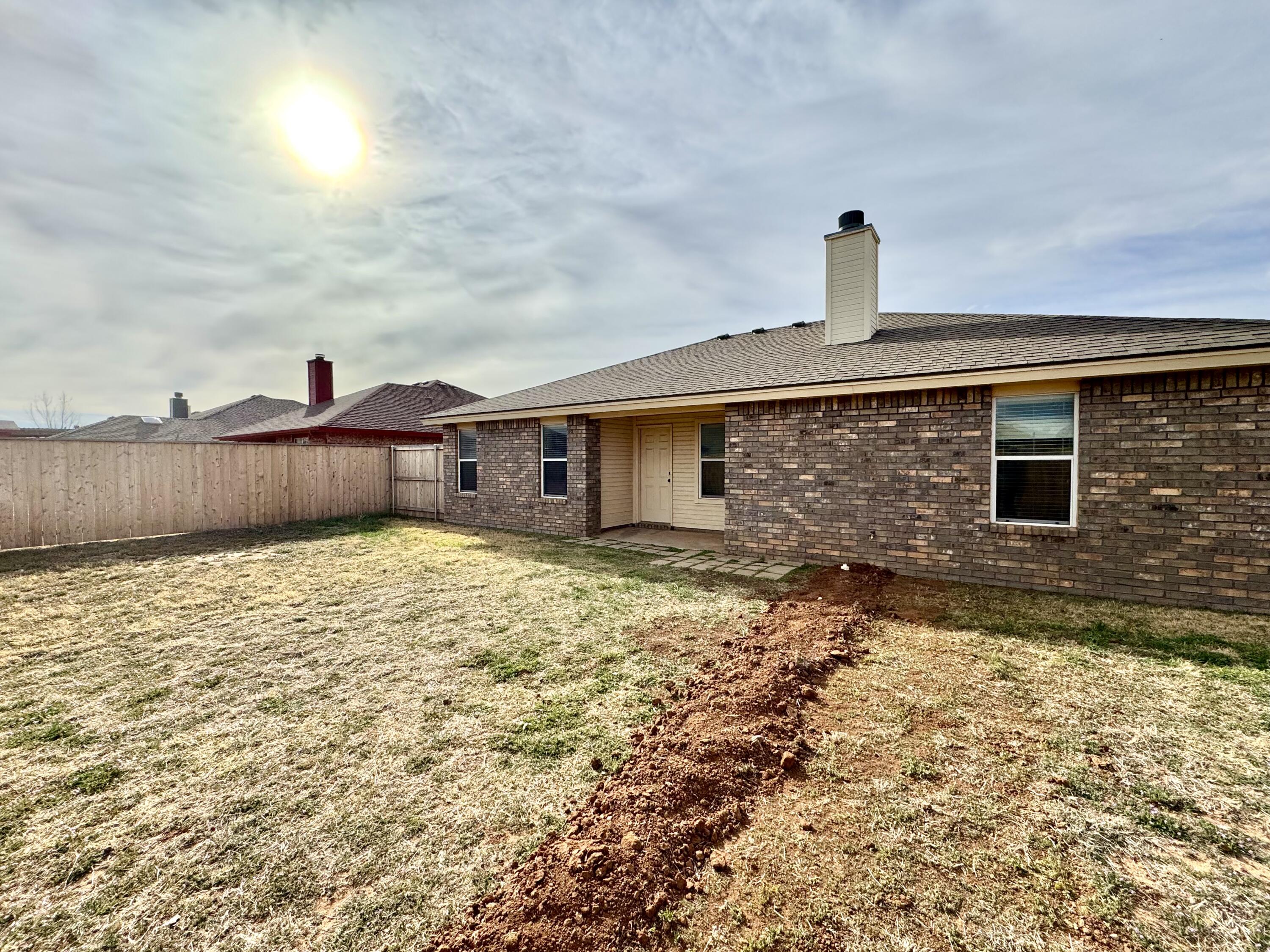 6536 7th Street Lubbock, TX 79416 - Photo 19 of 20 a front view of a house with a yard