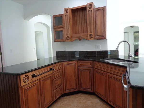 a kitchen with stainless steel appliances granite countertop a stove and a microwave