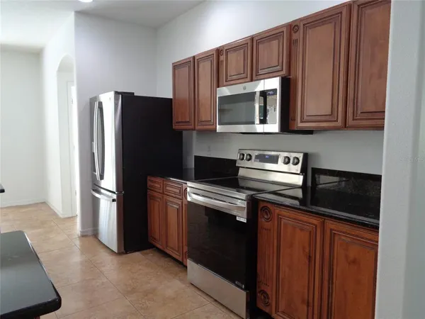 a kitchen with a sink and a refrigerator