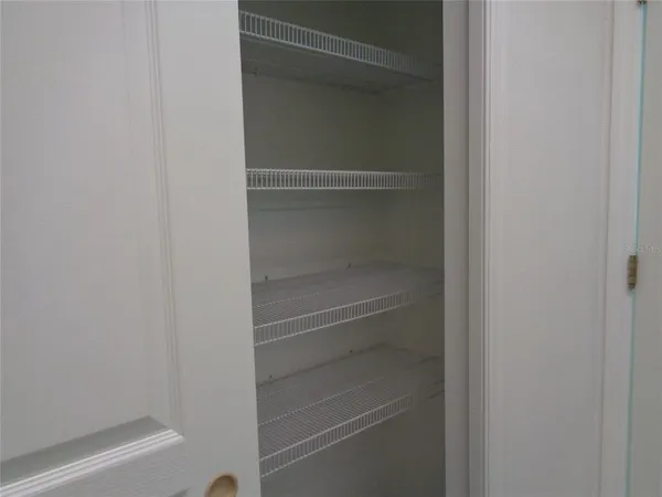 an empty room with wooden floor and a window