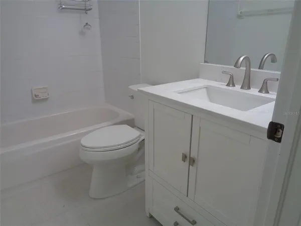 a kitchen with a refrigerator and cabinets