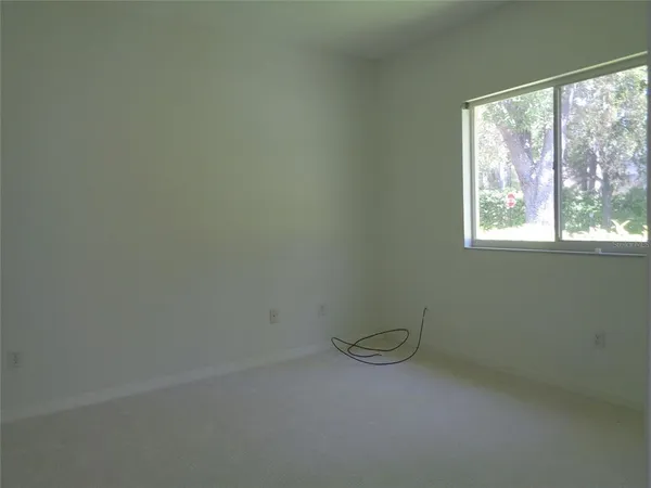 a view of a swimming pool with a large window and wooden fence
