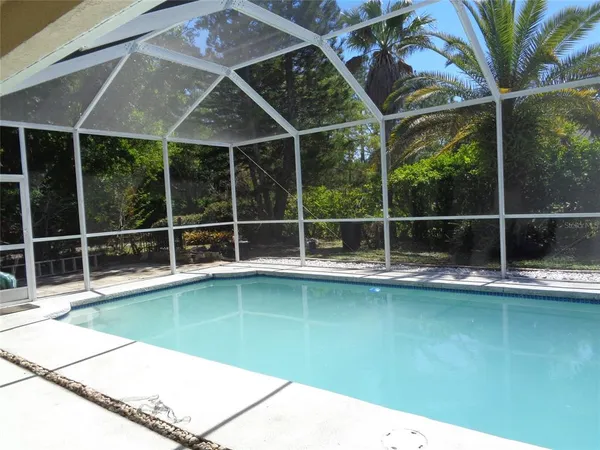 a house with swimming pool in front of it