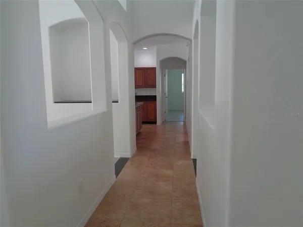 a kitchen with stainless steel appliances a sink a stove a microwave a sink a refrigerator and cabinets