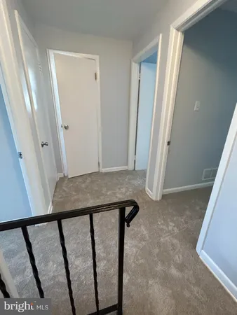 a view of a hallway with seating area