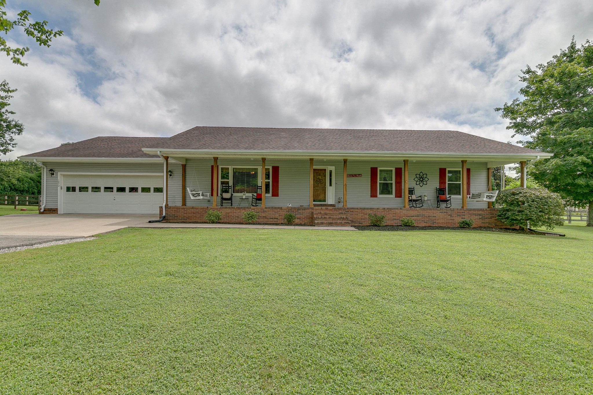 a front view of a house with a garden