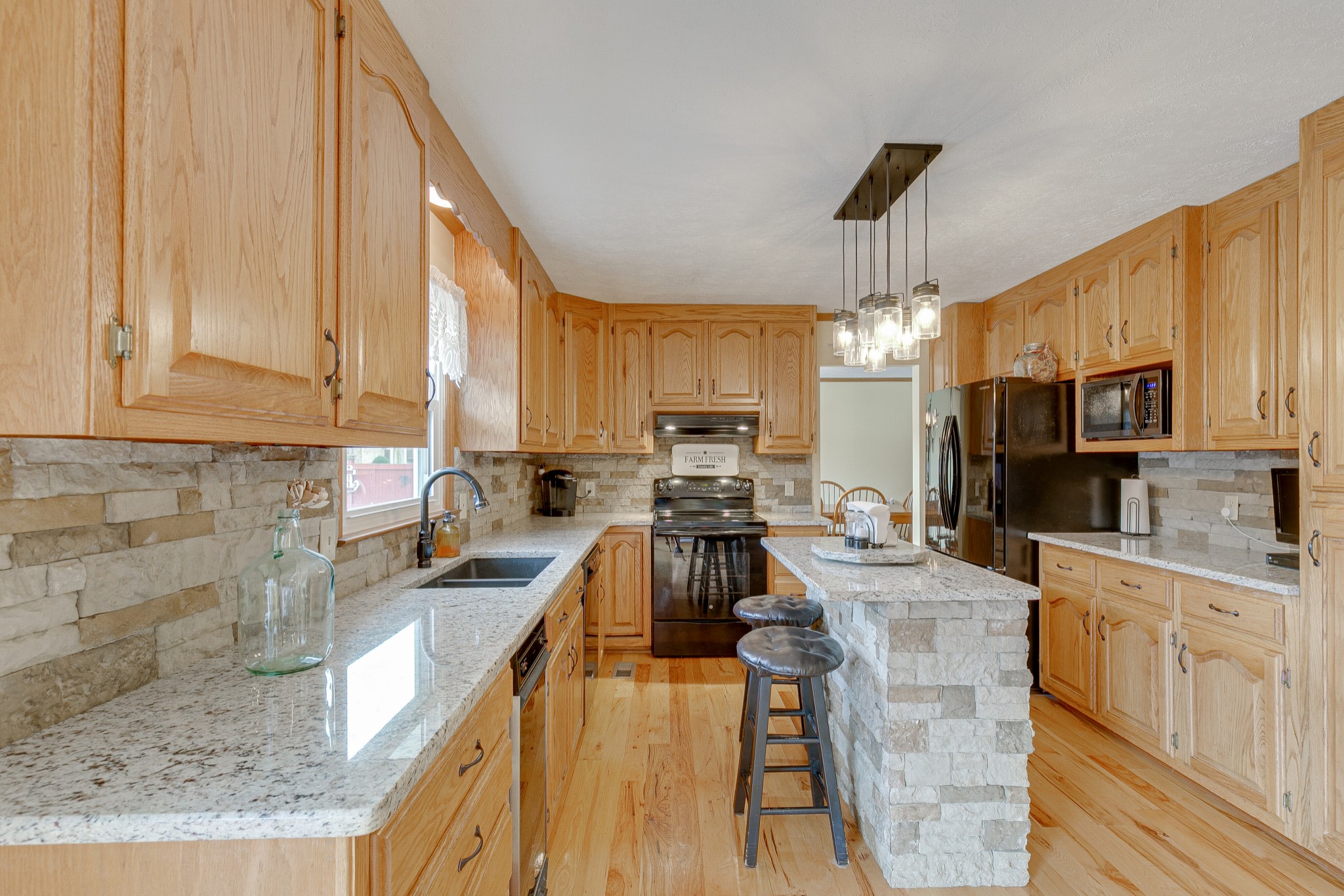 1872 Clara Mathis Road Spring Hill, TN 37174 - Photo 8 of 40 a kitchen with stainless steel appliances granite countertop a sink stove and refrigerator