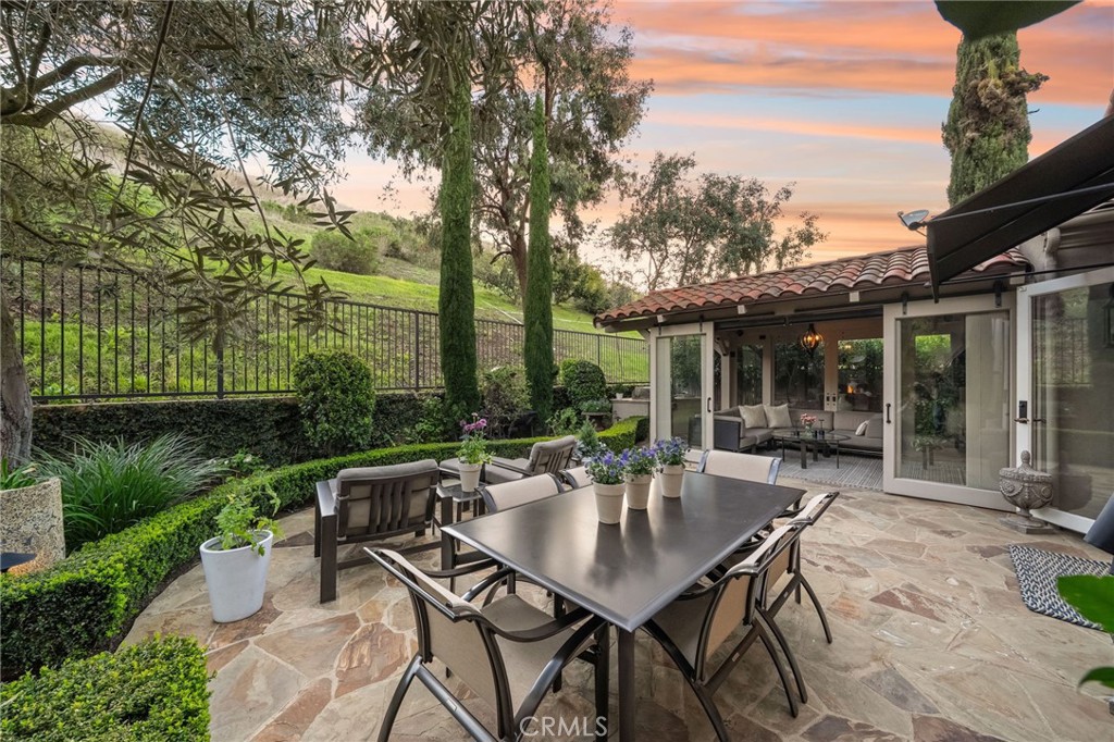 a view of a patio with a table chairs and a backyard
