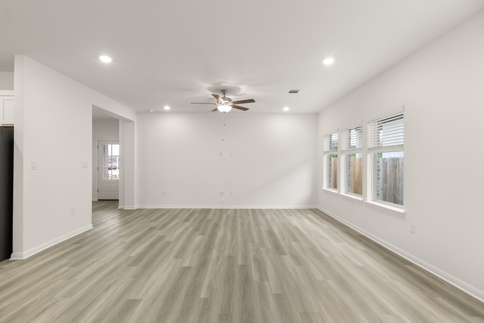 18605 Emu Lane Manor, TX 78653 - Photo 9 of 27 Spacious living area featuring light-colored flooring, recessed lighting, and a ceiling fan