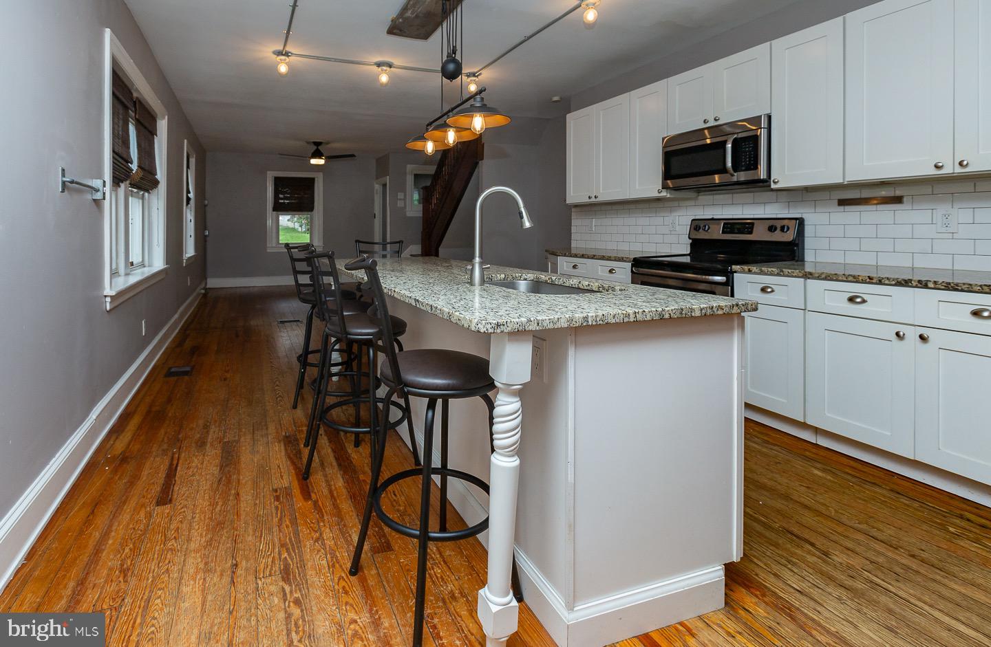 18 New Road Aston, PA 19014 - Photo 8 of 30 a kitchen with stainless steel appliances granite countertop a sink a stove and a refrigerator