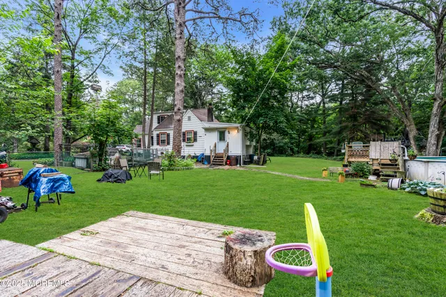a view of a house with backyard sitting area and garden