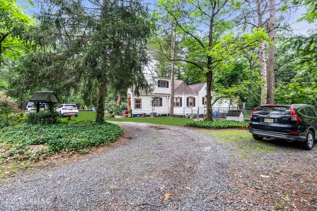 a car parked in front of a house with a small yard