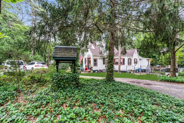 a view of a house with a yard and sitting area