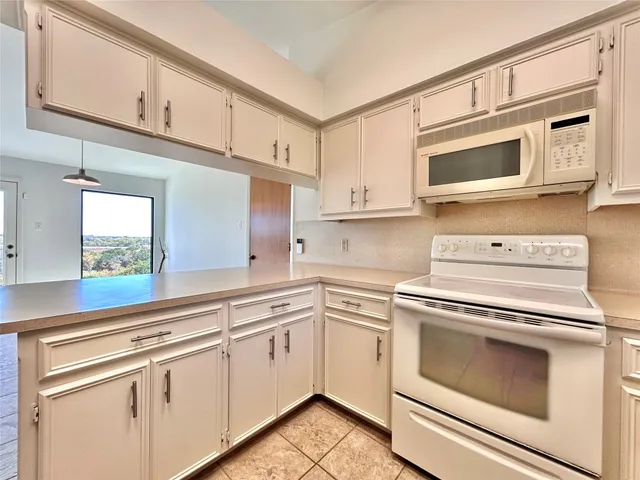 a kitchen with cabinets stainless steel appliances and a sink