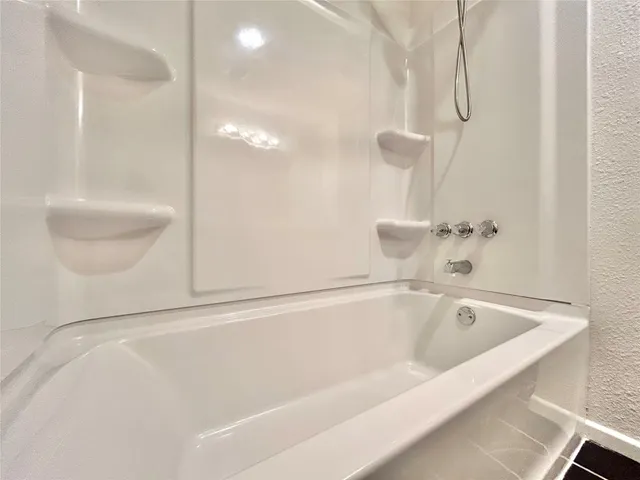 a bathroom with a bathtub and shower
