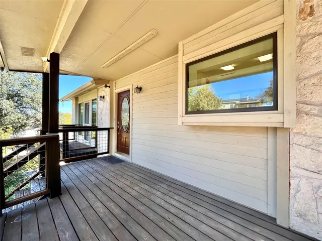 a view of a house with wooden floor next to a window