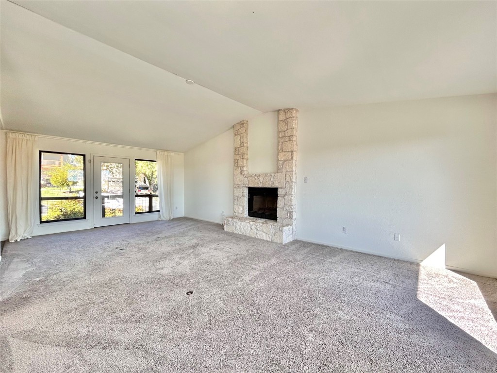 11205 Terrace Bluff Drive Austin, TX 78754 - Photo 7 of 37 a view of an empty room with a fireplace and a window