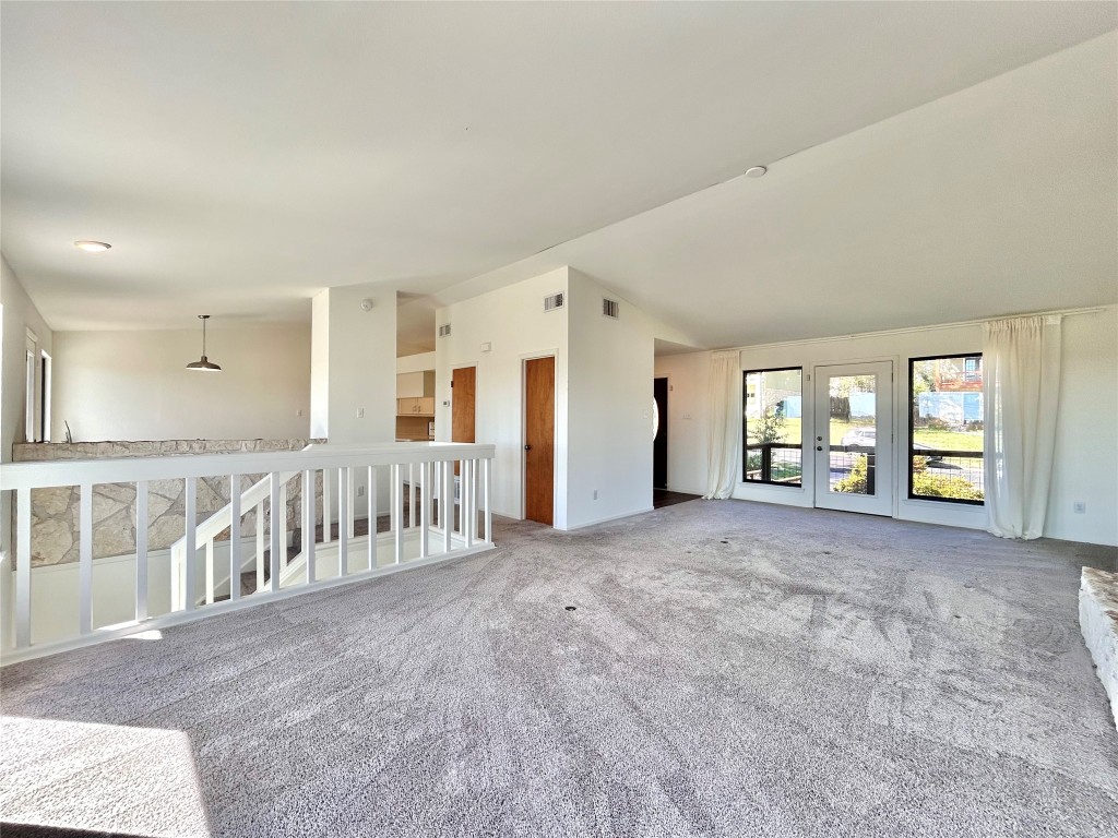 11205 Terrace Bluff Drive Austin, TX 78754 - Photo 8 of 37 a view of an empty room with windows & stairs