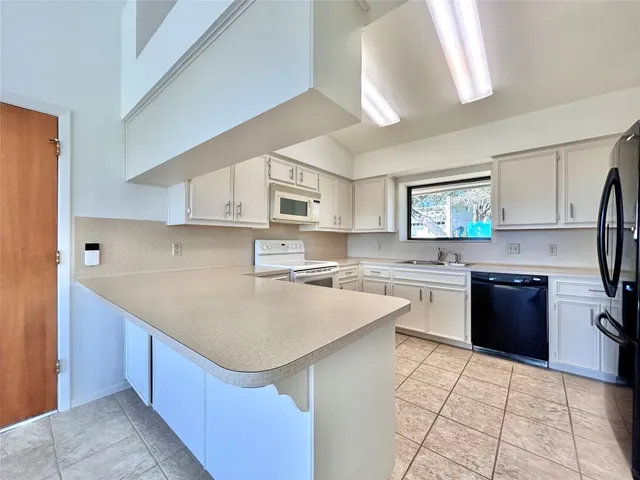 a kitchen with a sink stove and refrigerator