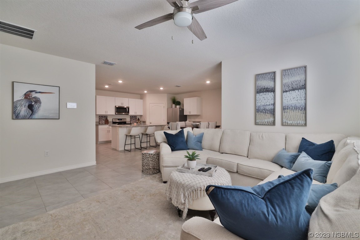 421 Anne Street DeLand, FL 32724 - Photo 11 of 44 a living room with furniture kitchen view and a window