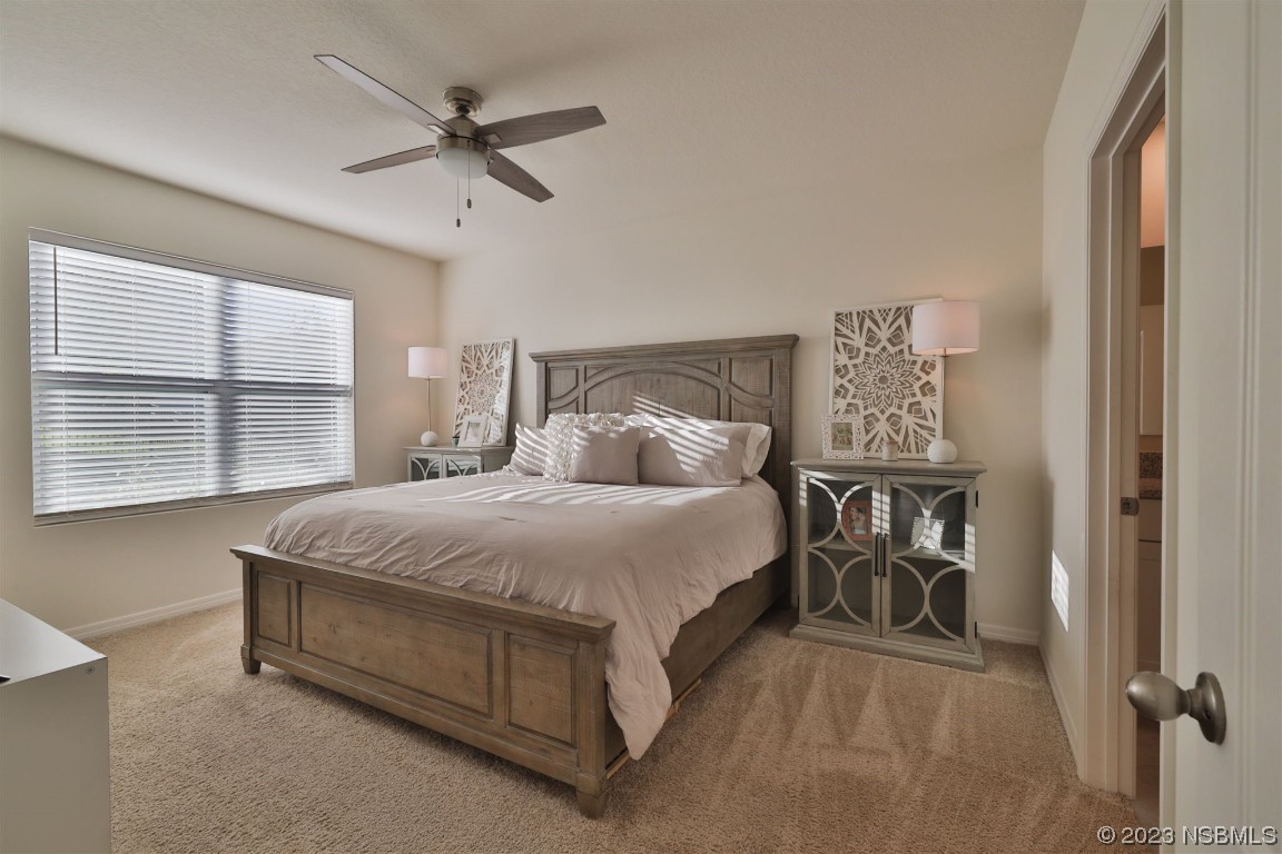 421 Anne Street DeLand, FL 32724 - Photo 13 of 44 a large bed sitting in a bedroom next to a window