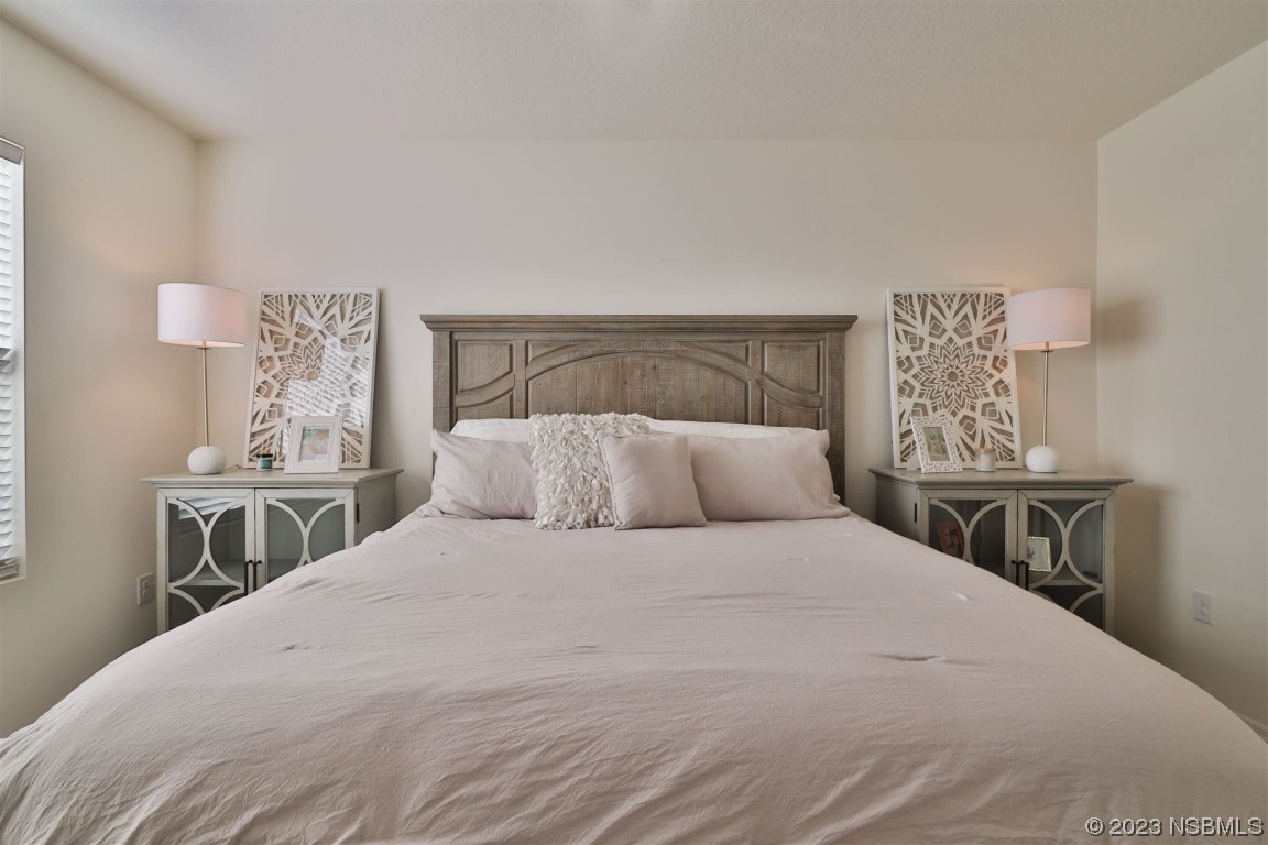 421 Anne Street DeLand, FL 32724 - Photo 14 of 44 a large white bed in a bedroom and lamp