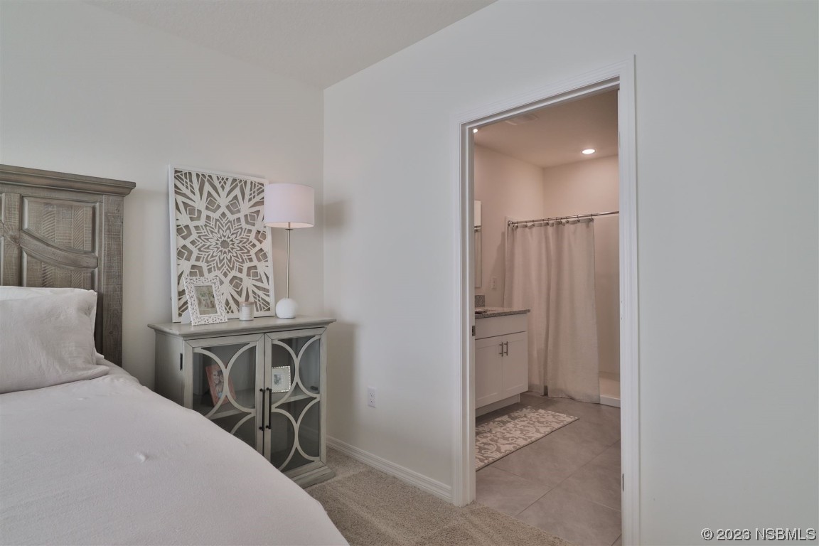 421 Anne Street DeLand, FL 32724 - Photo 15 of 44 a bedroom with a bed and a table in it