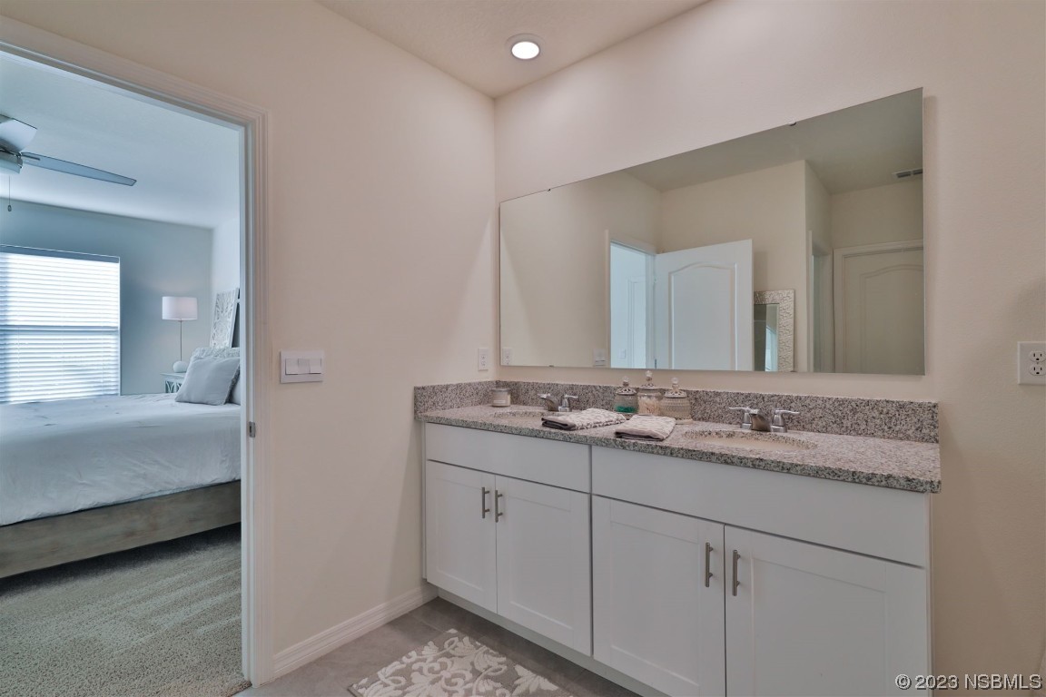 421 Anne Street DeLand, FL 32724 - Photo 16 of 44 a en suite bathroom with a granite countertop sink and a mirror
