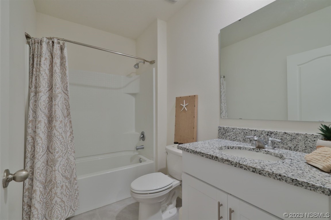 421 Anne Street DeLand, FL 32724 - Photo 20 of 44 a bathroom with a granite countertop sink toilet and shower