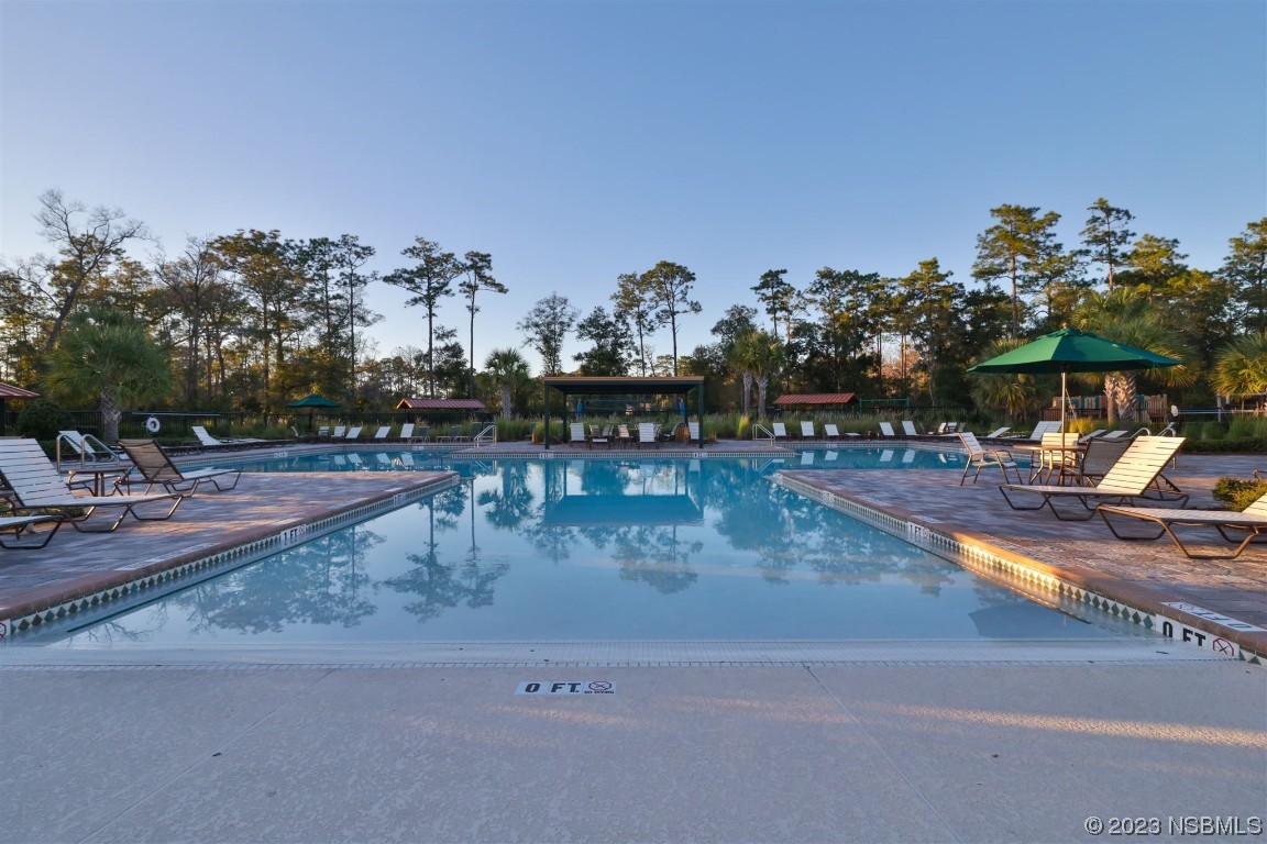 421 Anne Street DeLand, FL 32724 - Photo 31 of 44 a view of a swimming pool with an outdoor space and seating area