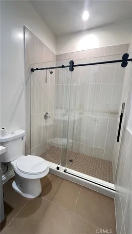 a bathroom with a toilet and a shower