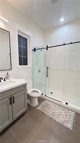 a bathroom with a toilet sink and shower