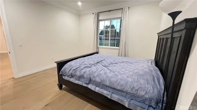 a bed sitting in a bedroom next to a window