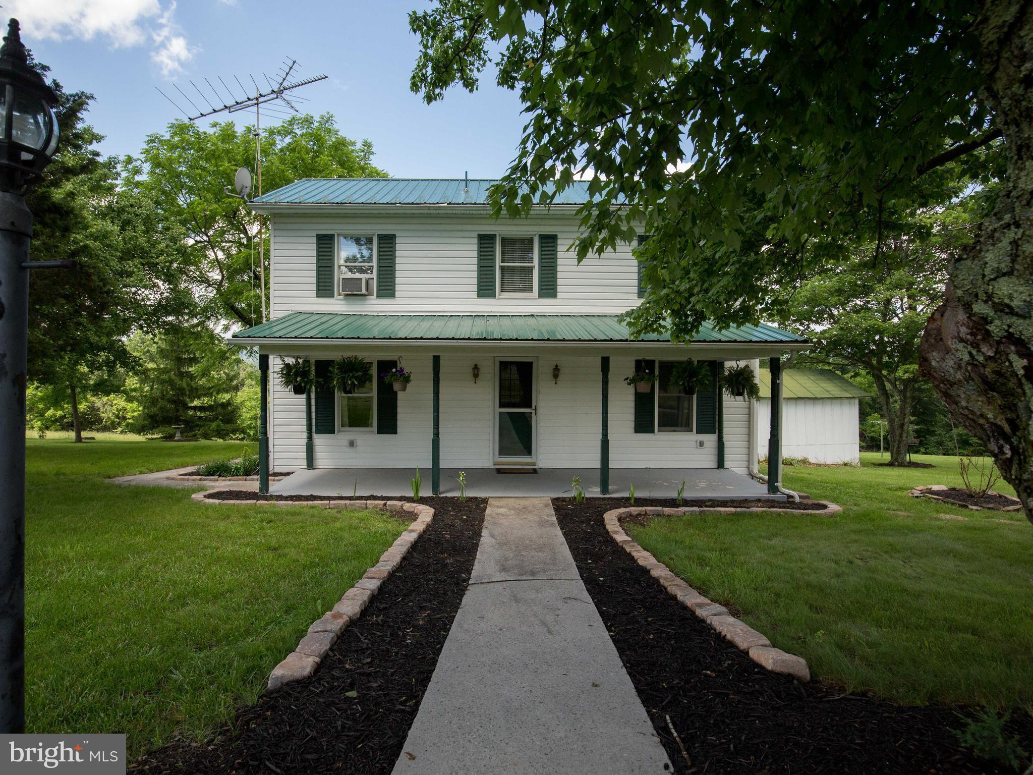 2902 Timber Ridge Road Berkeley Springs, WV 25411 - Photo 1 of 30 a front view of a house with a yard