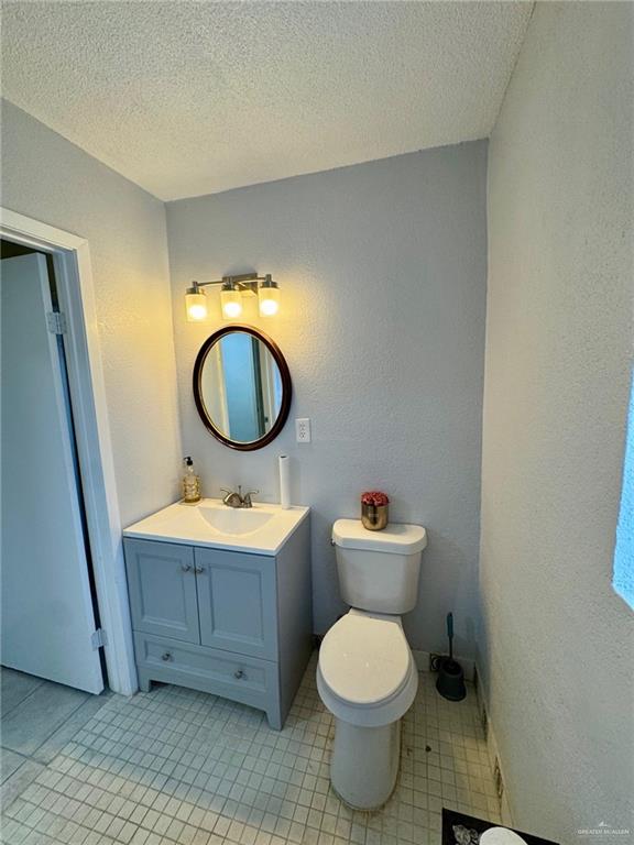 3813 North Taylor Road Mission, TX 78573 - Photo 16 of 29 a bathroom with a toilet a sink and a mirror