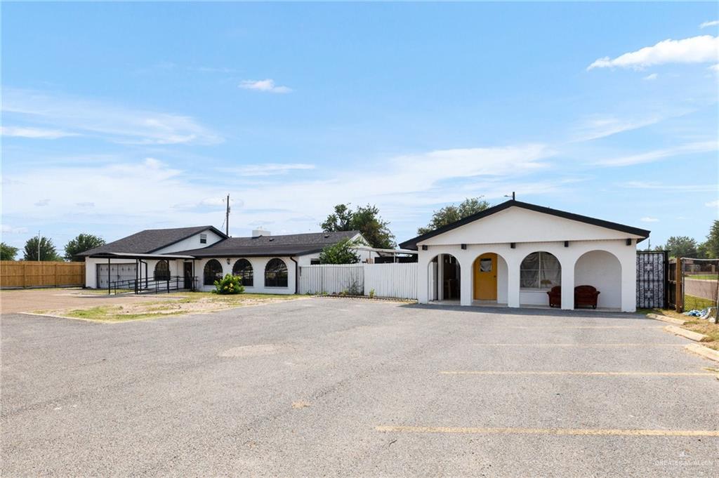 3813 North Taylor Road Mission, TX 78573 - Photo 3 of 29 a view of a white house with a yard and large trees