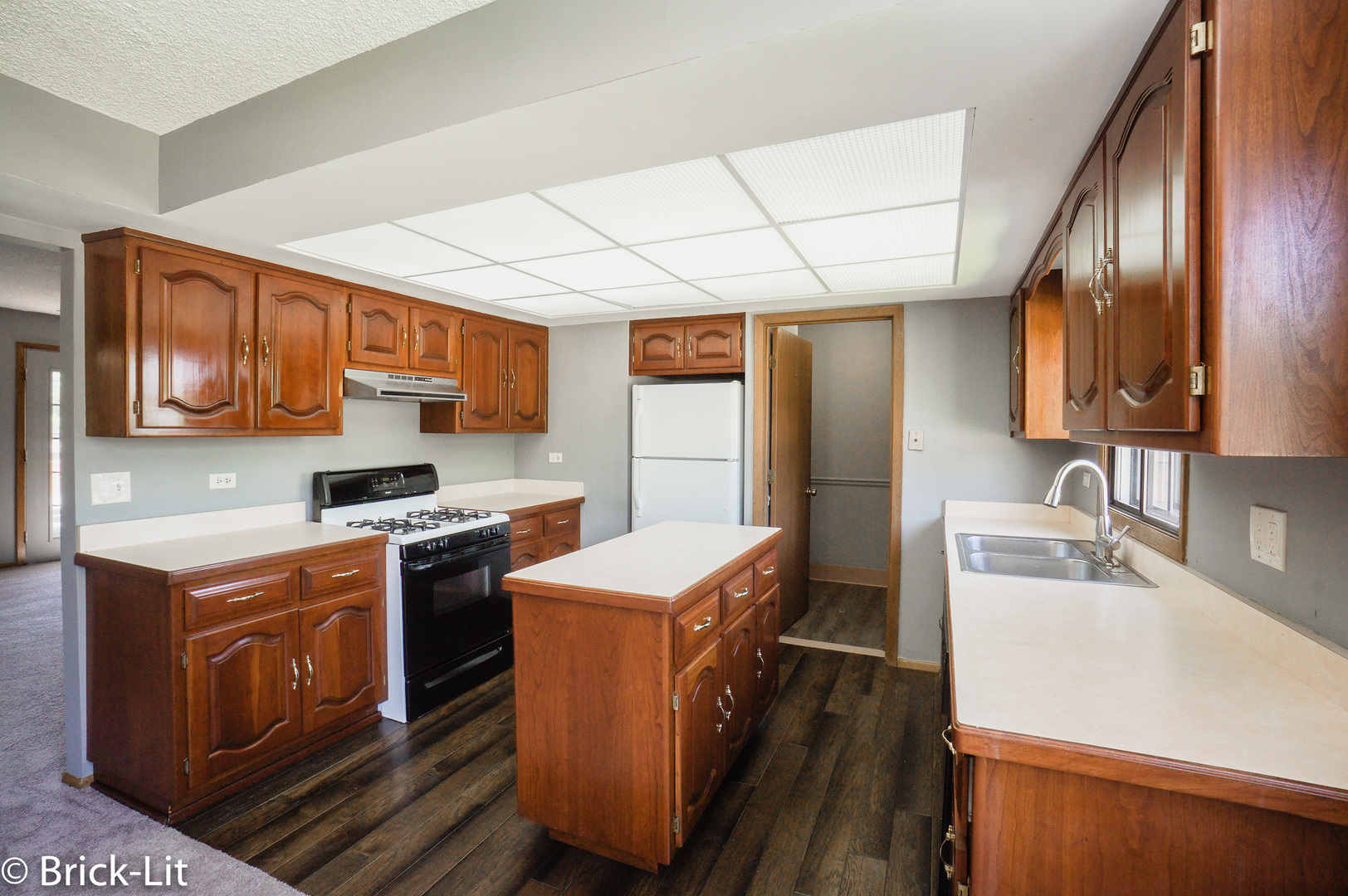 19444 Wolf Road, Unit 3 Mokena, IL 60448 - Photo 11 of 18 a kitchen with stainless steel appliances granite countertop a sink stove and refrigerator