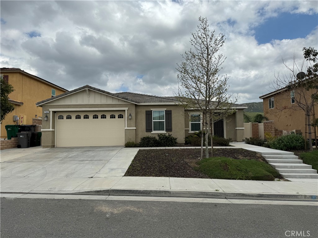 a view of a white house with a large windows and a yard