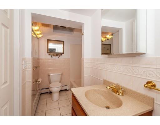 28 Constitution Road Lexington, MA 02421 - Photo 14 of 25 a bathroom with a sink mirror and toilet