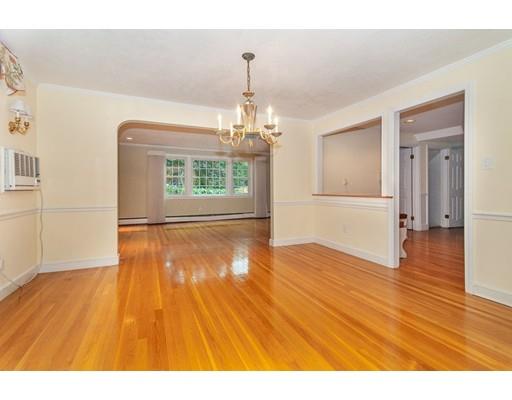 28 Constitution Road Lexington, MA 02421 - Photo 10 of 25 a big room with wooden floor windows and a chandelier